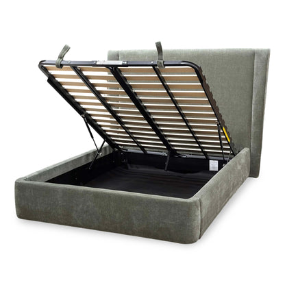Side profile of the ‘Dior’ ottoman bed, highlighting the majestic height and plush padding of the winged headboard, low-profile footboard, and solid floor-hugging base.