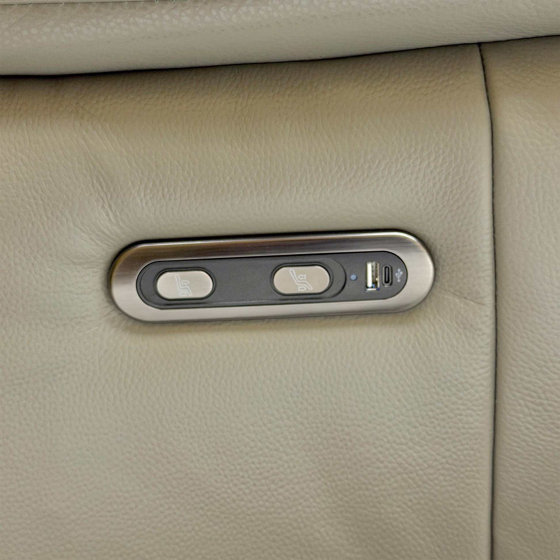Detail shot of the chrome-finished power control buttons on the side of the sofa, including the built-in USB charging port.