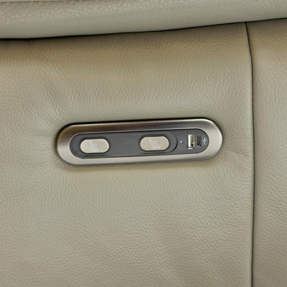 Detail shot of the chrome-finished power control buttons on the side of the sofa, including the built-in USB charging port.