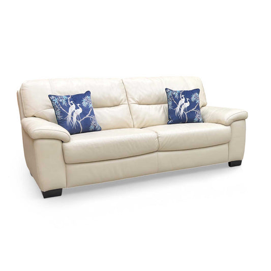 Full view of the World of Leather Hetty 3-seater sofa in Bisque leather, featuring a modern low-profile design and wide padded armrests.