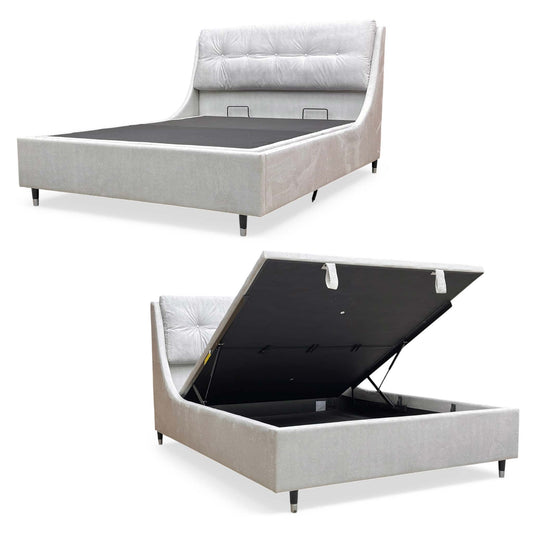 Full view of the Javier King size end-lift ottoman bed frame in Smooth Stone velvet, featuring a tall padded headboard and a luxurious upholstered frame.