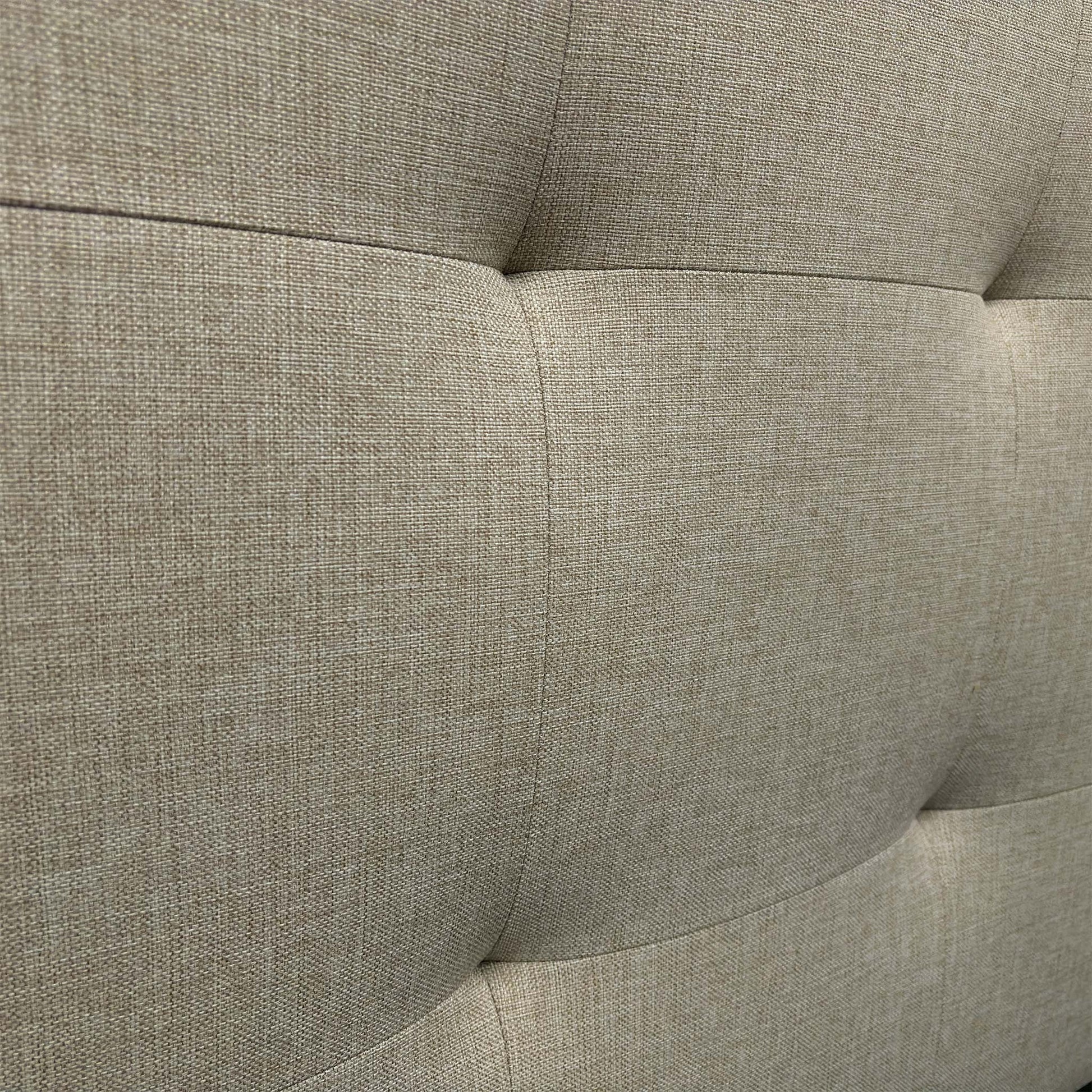Close-up of the Oatmeal fabric, highlighting the soft woven texture and the precision stitching on the headboard panel.