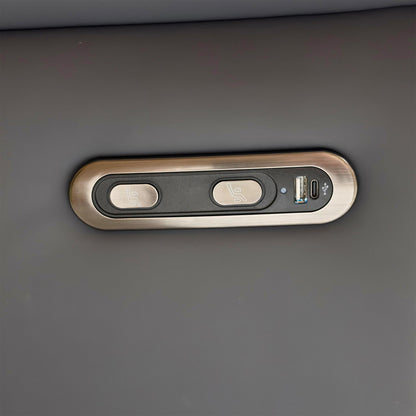 Detail shot of the power control buttons on the side of the armrest, showing the integrated USB charging port.