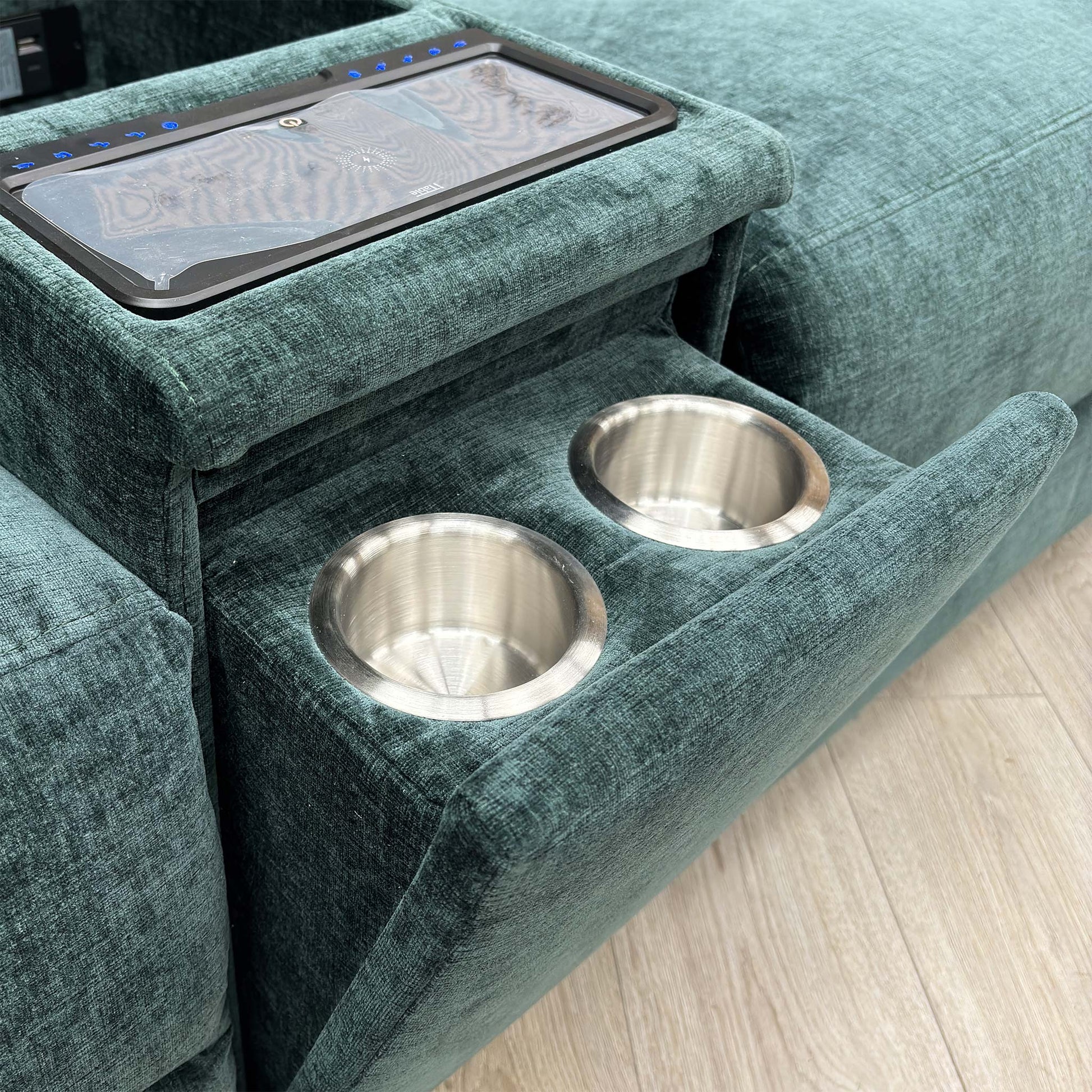 Detail shot of the integrated Bluetooth speakers and the central console with stainless steel cup holders and storage compartment.