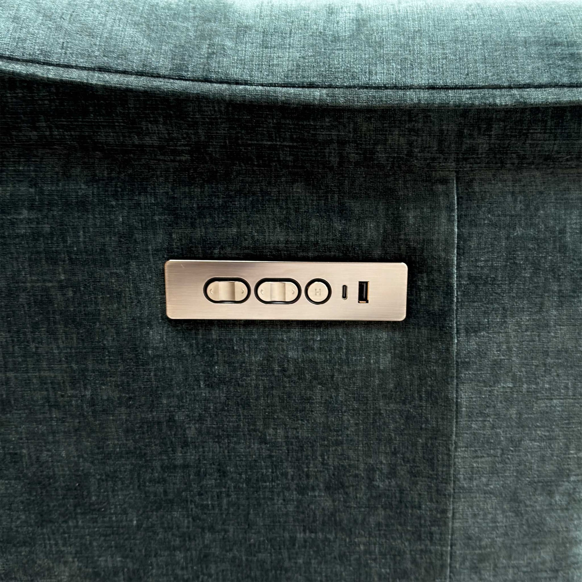 Detail shot of the central audio control panel and speakers, showing the Bluetooth interface and integrated cup holders.