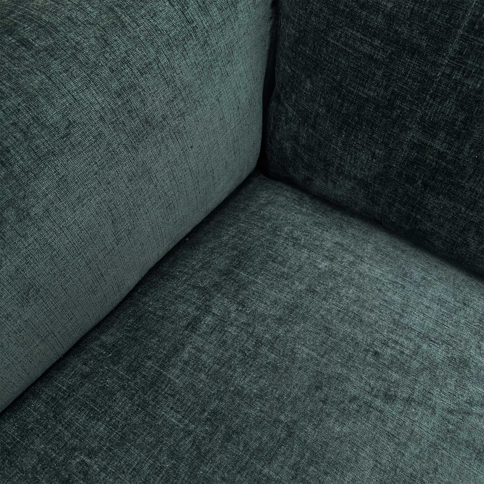 Close-up of the Forest Green linen-style fabric, highlighting the textured weave and the high-quality stitching on the armrests.