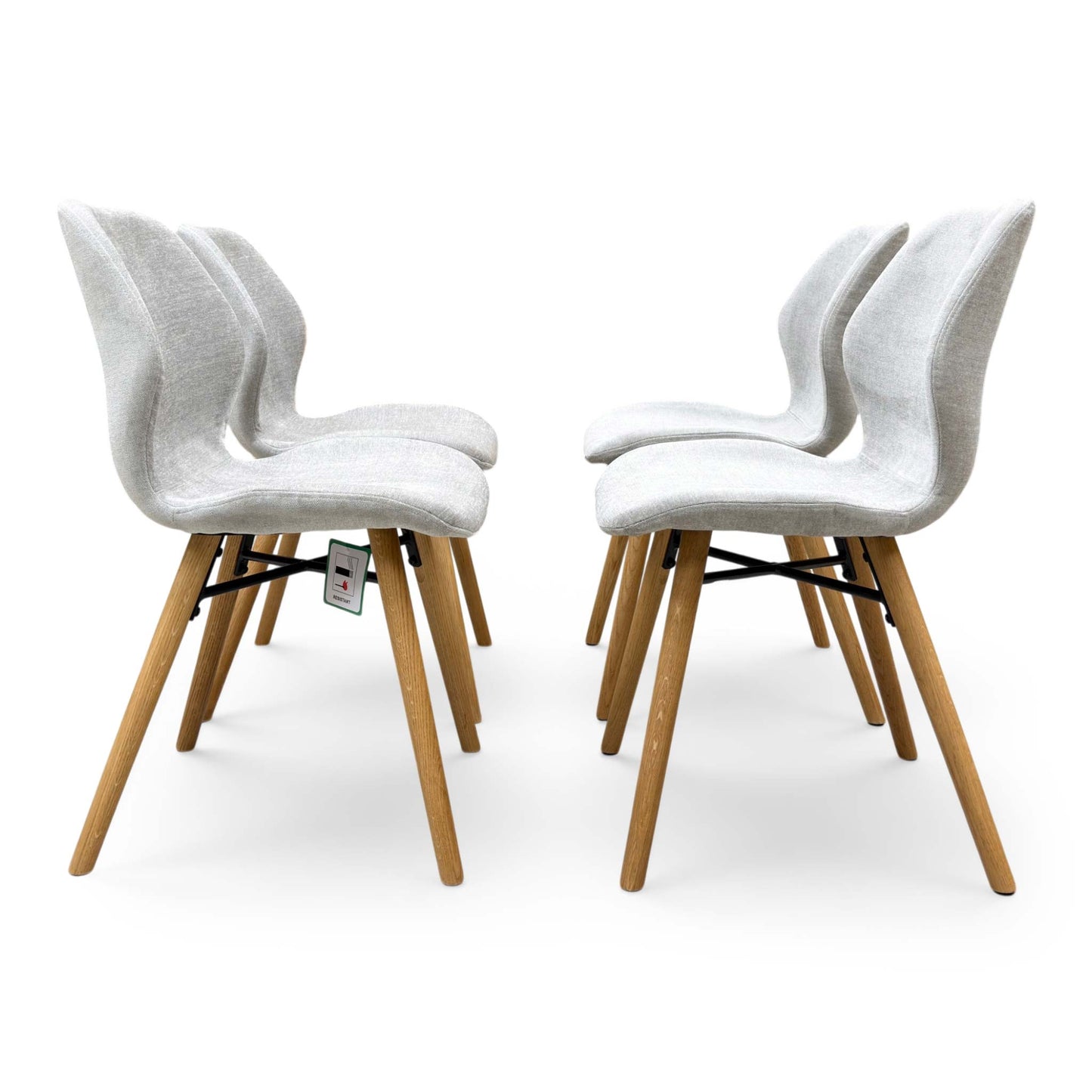 Front shot of the solid oak legs with a soft-sheen finish, emphasizing the handmade craftsmanship and stability of the dining chairs.