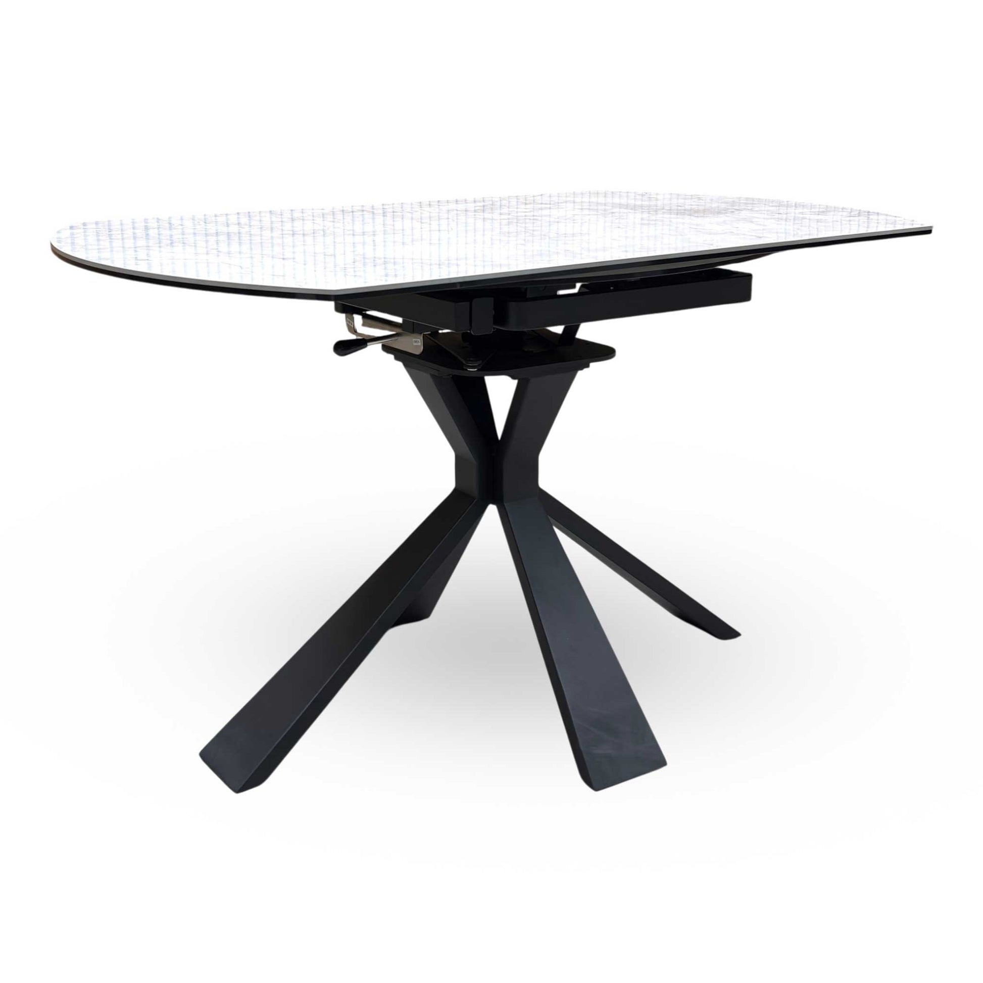 Full view of the ‘Crete’ round swivel extending dining table featuring a sophisticated grey stone-effect ceramic top and a dramatic black powder-coated starburst pedestal base.