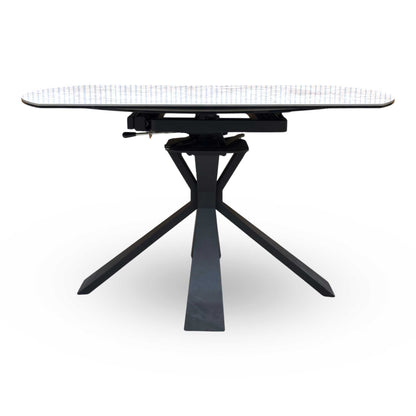 Side view of the Crete table fully extended into an oval shape, demonstrating the increased surface area perfect for hosting larger dinner parties and family gatherings.