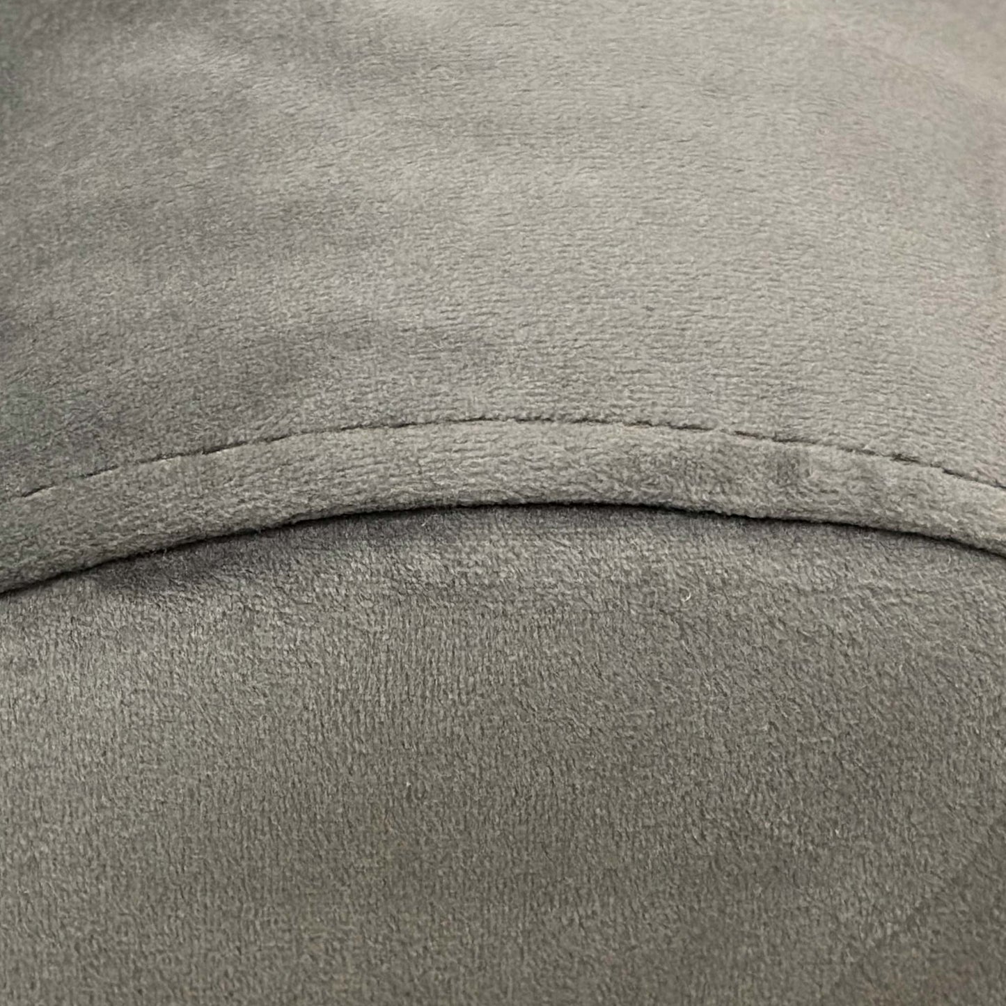 Close-up of the Charcoal Velvet upholstery, showing the high-quality vertical stitching (fluting) and the depth of the dark grey fabric.