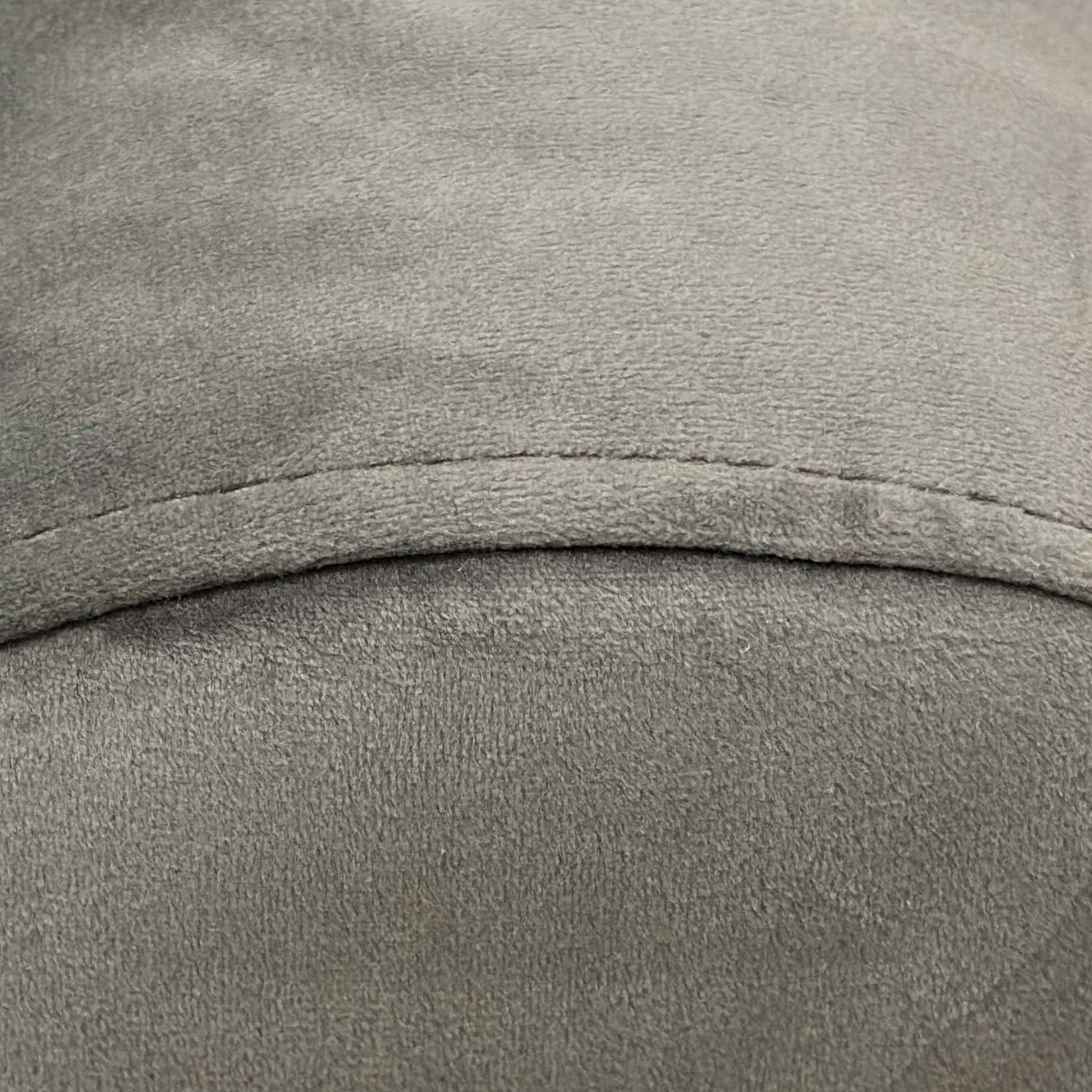 Close-up of the Charcoal Velvet upholstery, showing the high-quality vertical stitching (fluting) and the depth of the dark grey fabric.
