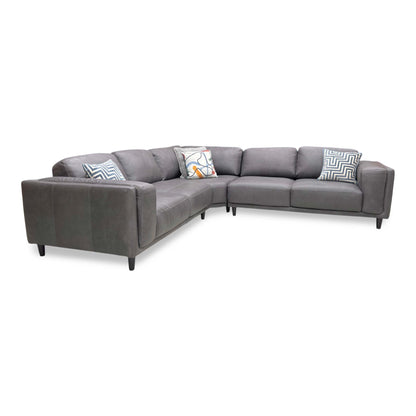 Side profile of the Brody corner sofa, emphasizing the deep seating area and the elegant angle of the back cushions for ergonomic support.