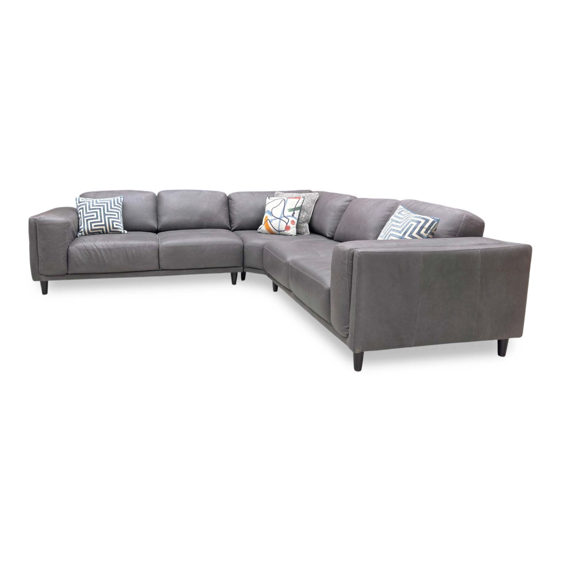 Side profile of the Brody corner sofa, emphasizing the deep seating area and the elegant angle of the back cushions for ergonomic support.