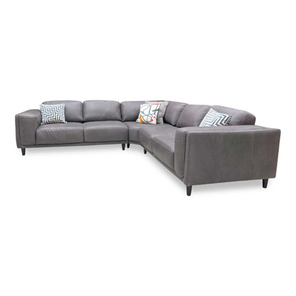 Side profile of the Brody corner sofa, emphasizing the deep seating area and the elegant angle of the back cushions for ergonomic support.