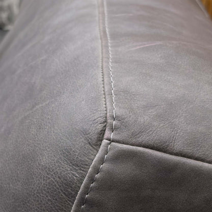 Close-up detail of the Grey Italian Leather upholstery, showing the natural grain, high-quality stitching, and soft texture of the premium hide.