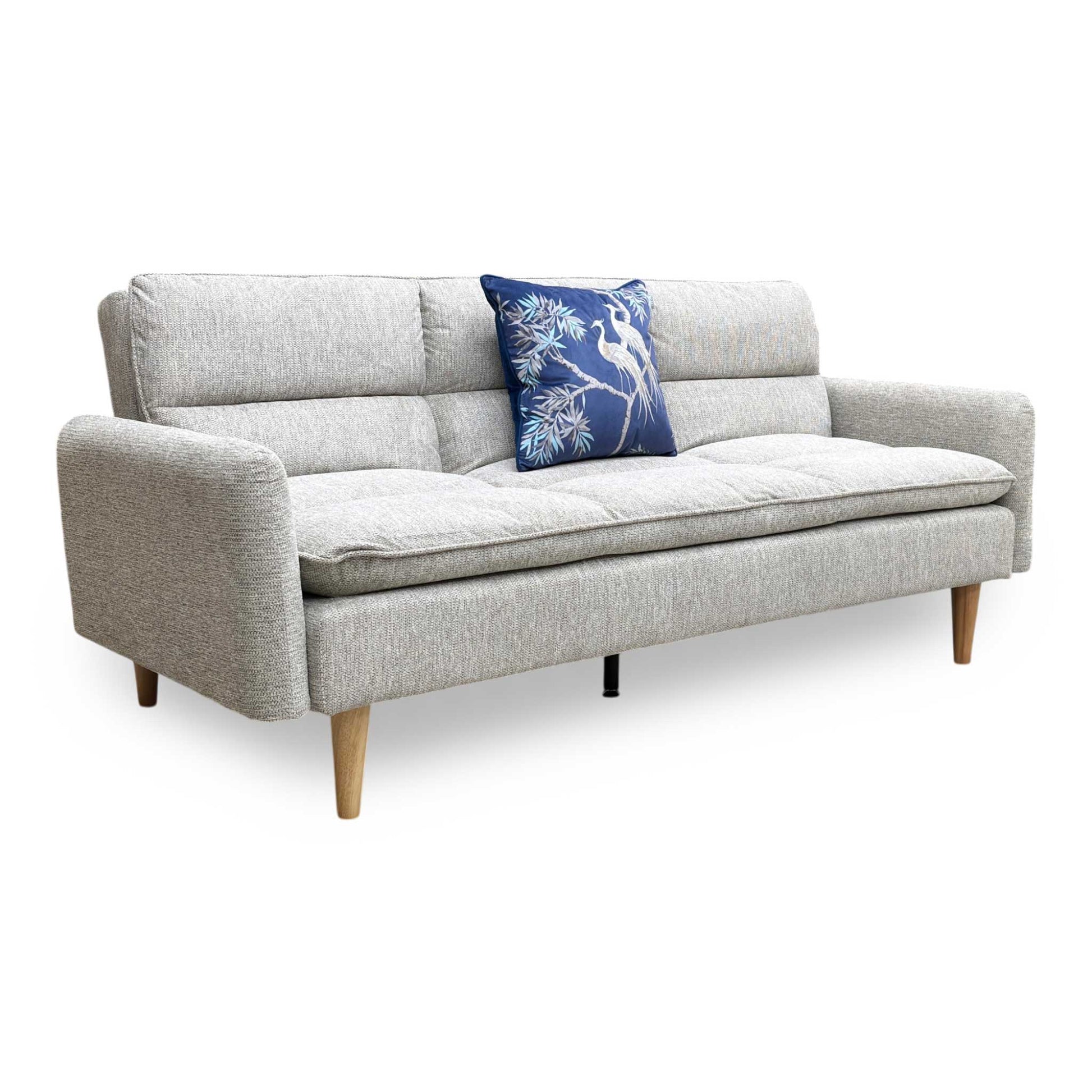 Side profile of the Chill sofa, emphasizing the sleek, low-profile design and the sturdy angle of the natural wood supporting legs.