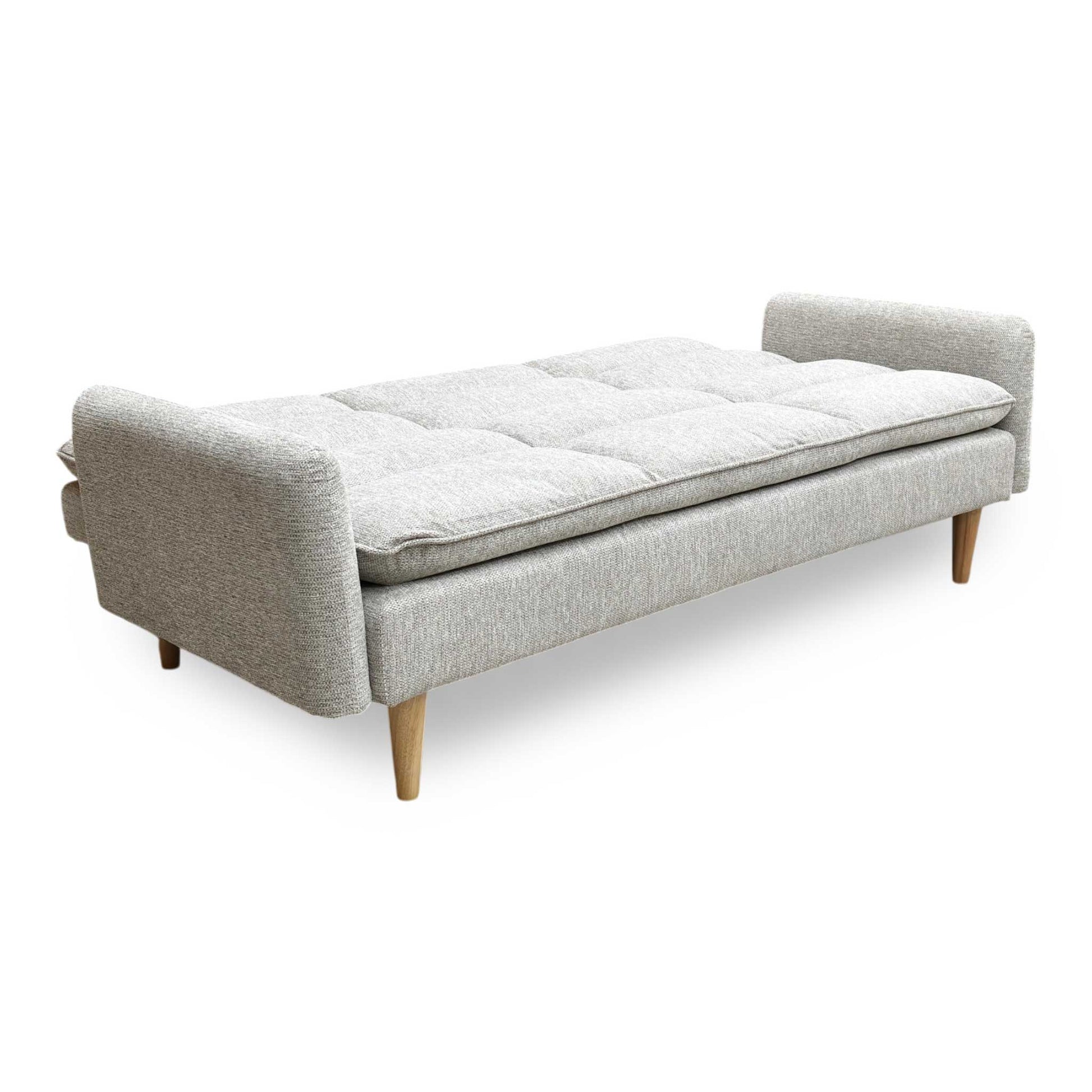 Side profile of the Chill sofa, emphasizing the sleek, low-profile design and the sturdy angle of the natural wood supporting legs.
