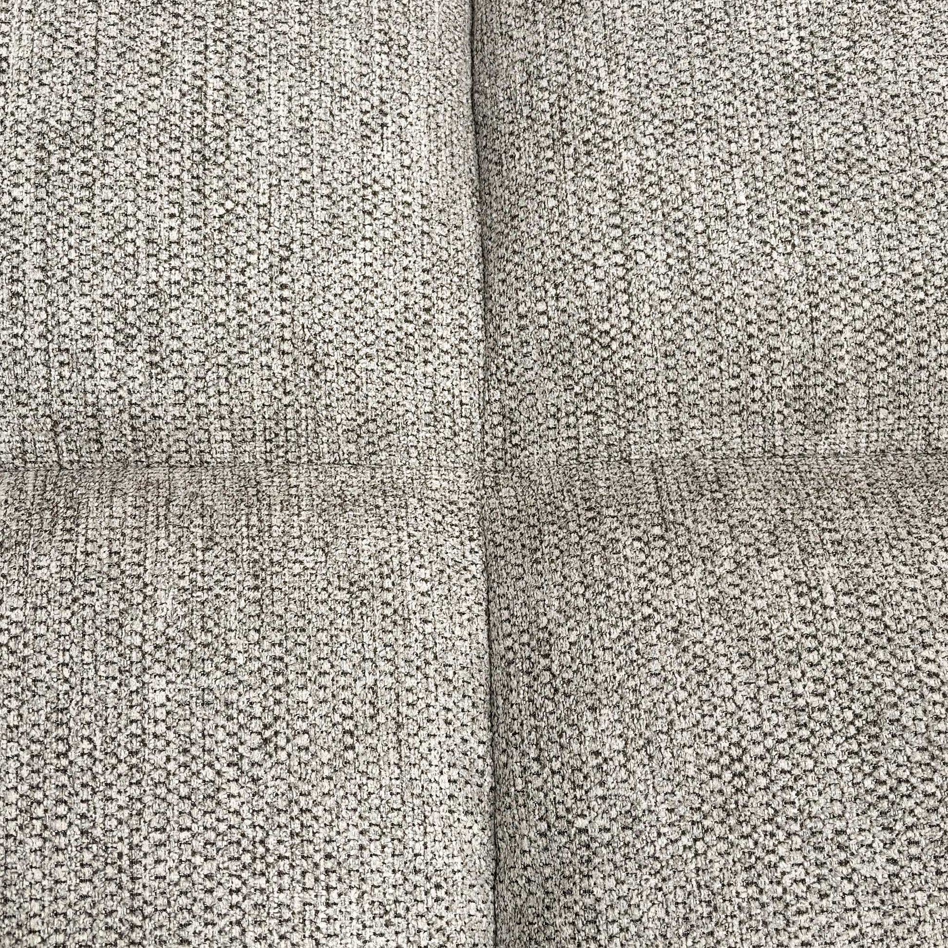 Close-up shot of the natural-toned fabric, highlighting the durable weave texture and the refined vertical channeled stitching on the backrest.