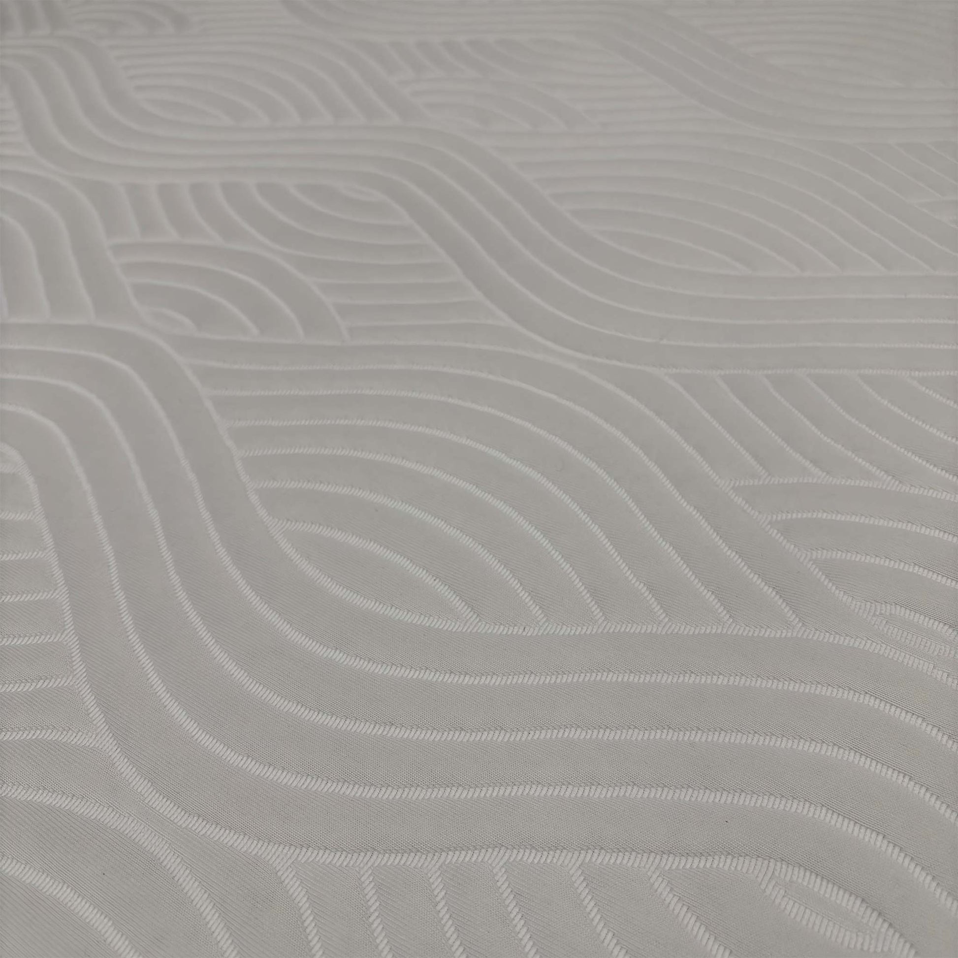 Close-up macro shot of the mattress surface, highlighting the luxurious, breathable top cover weave and cooling ventilation mesh along the sides.