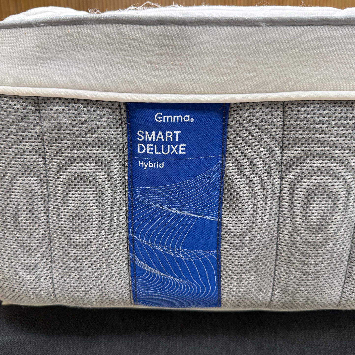 High-definition close-up macro view of the specialized temperature-regulating top cover fabric, detailing the advanced knitted cooling textile pattern and breathable mesh weave.