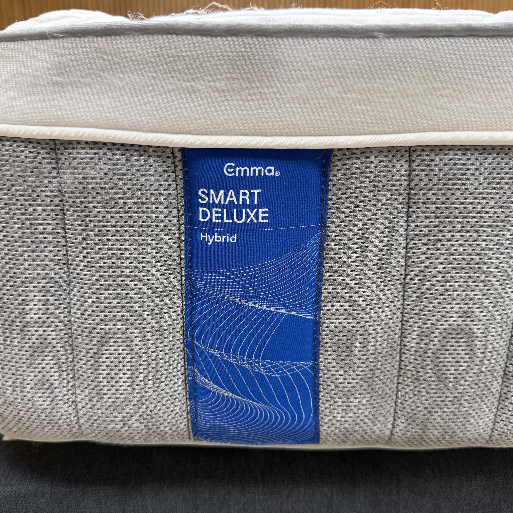High-definition close-up macro view of the specialized temperature-regulating top cover fabric, detailing the advanced knitted cooling textile pattern and breathable mesh weave.