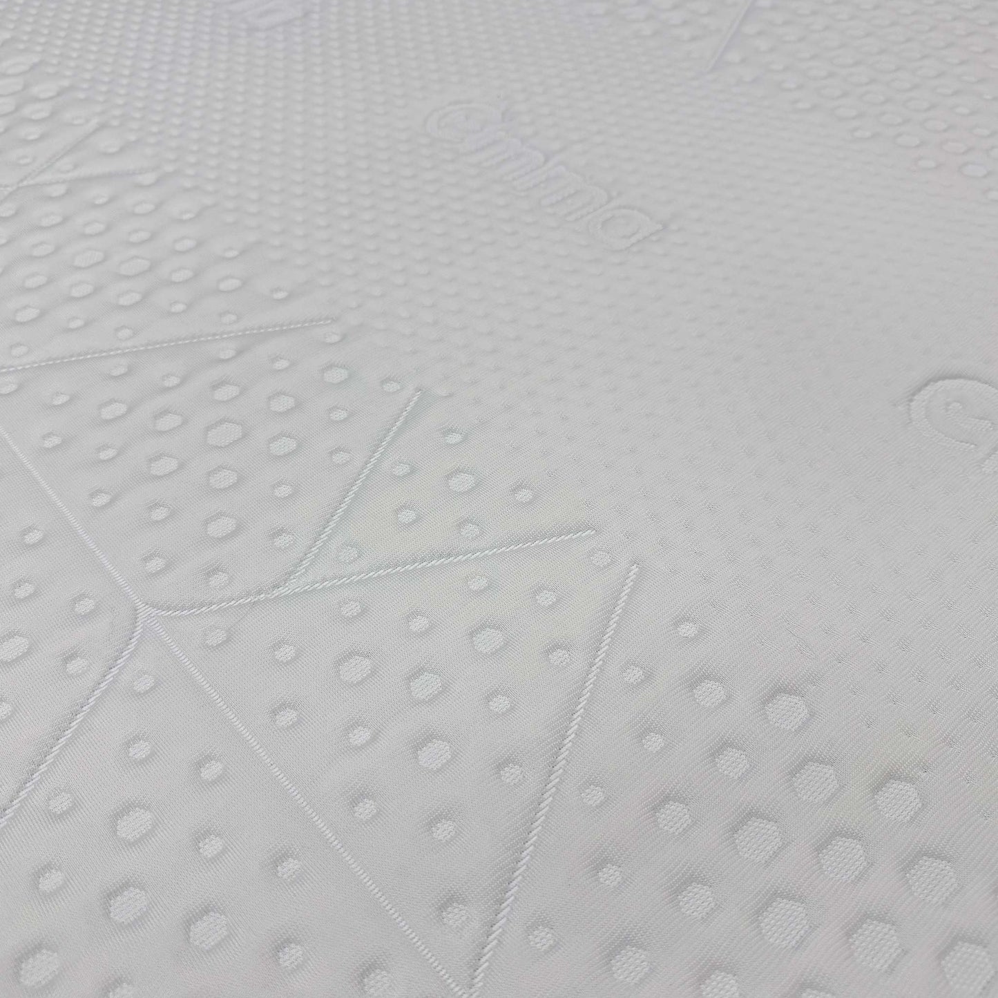 High-definition close-up macro view of the specialized temperature-regulating top cover fabric, detailing the advanced knitted cooling textile pattern and breathable mesh weave.