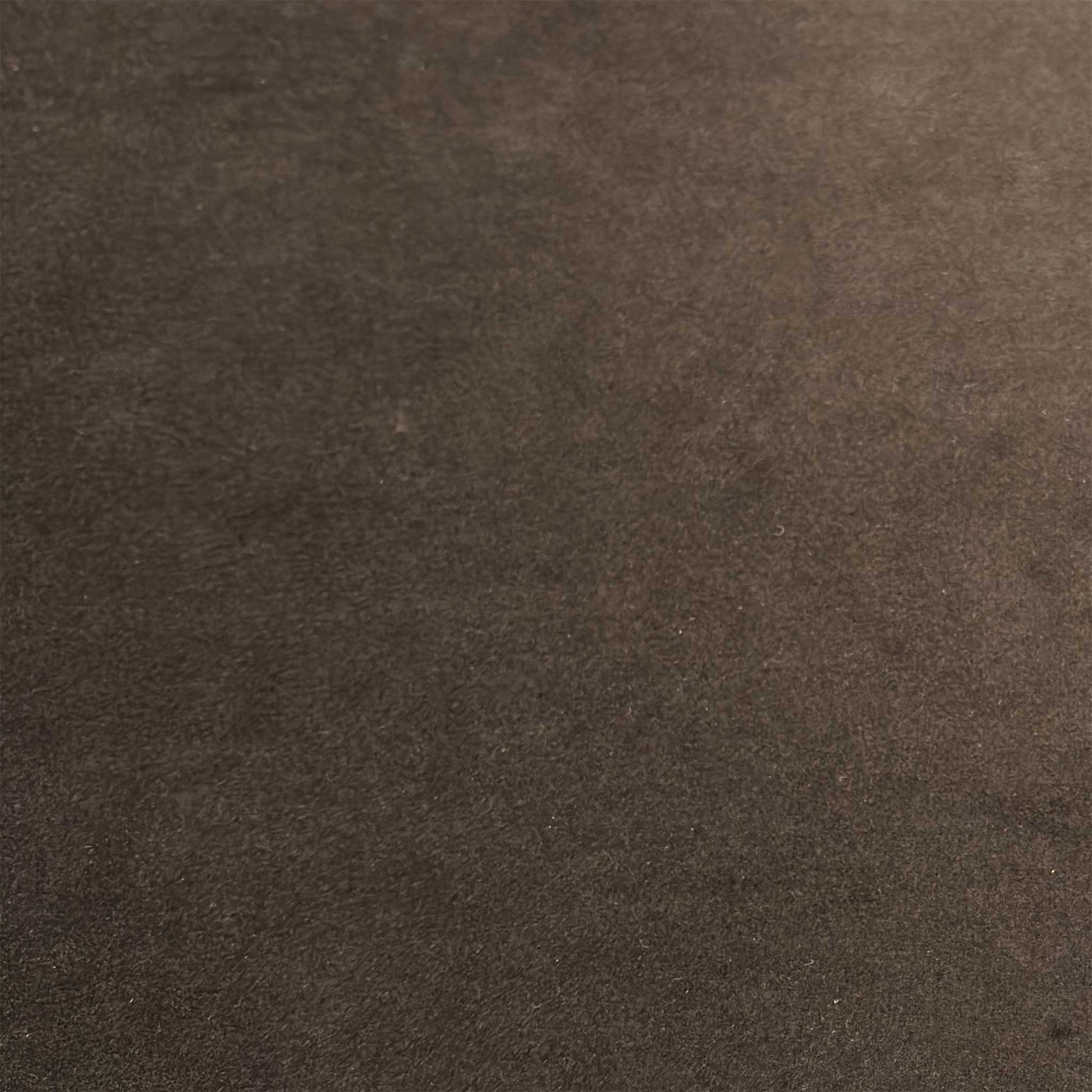 Close-up macro shot of the premium Stella brown velvet upholstery, detailing the soft touch texture, fine fiber depth, and rich warm brown color tones.