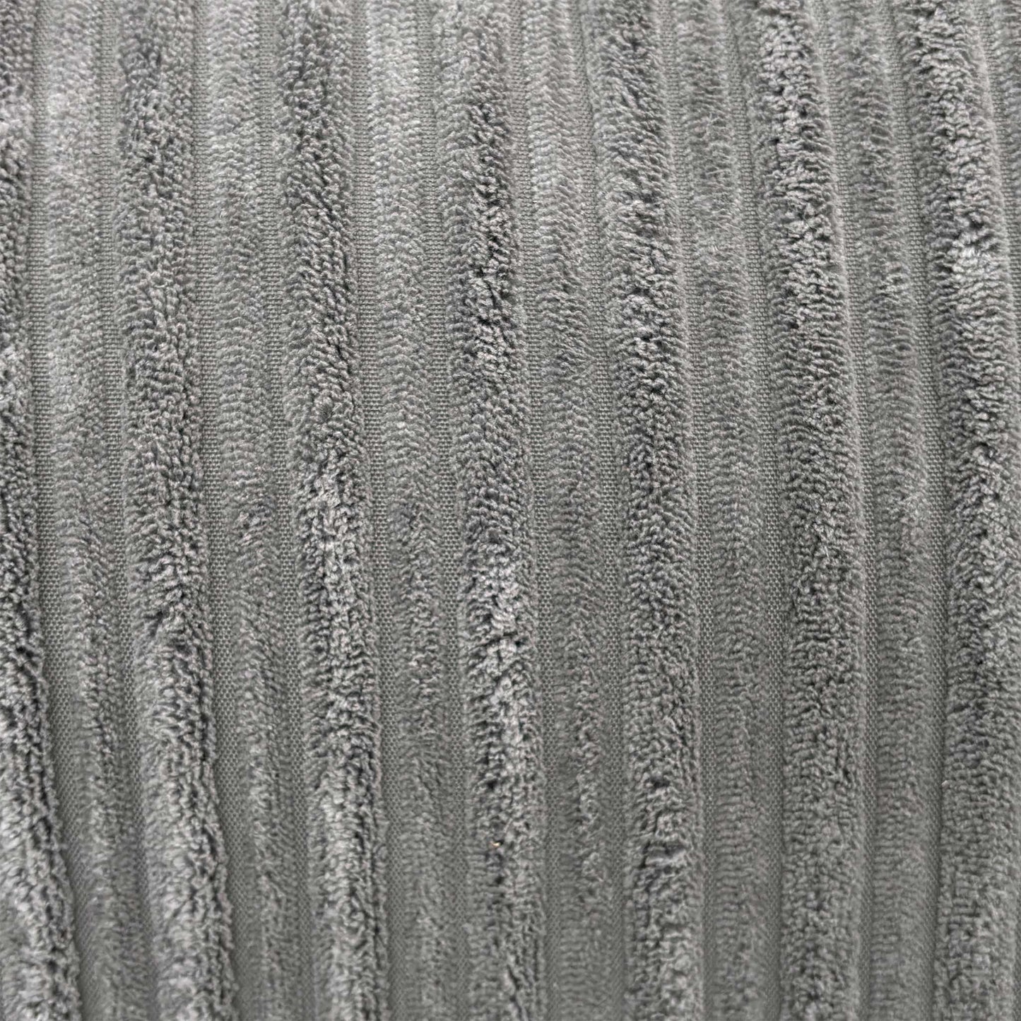 Close-up macro view of the luxury slate grey jumbo cord fabric, detailing the wide-ribbed corduroy texture and soft fiber construction.