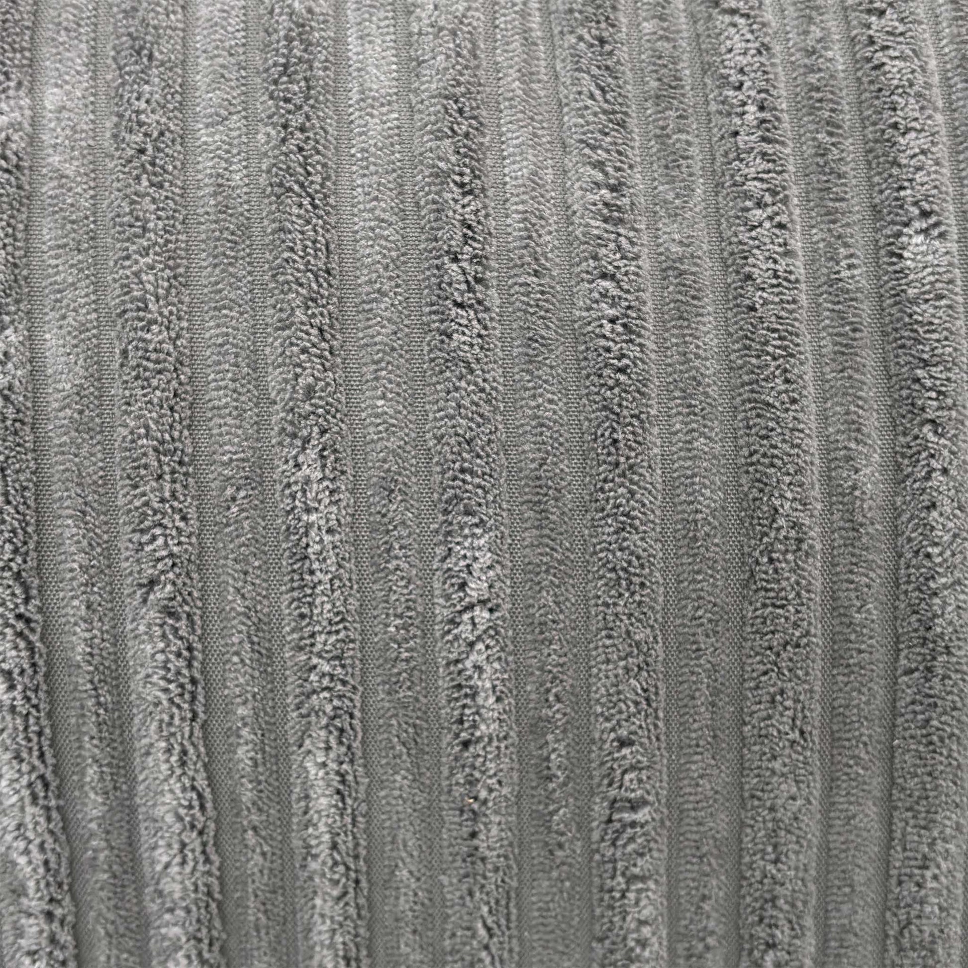 Close-up macro view of the luxury slate grey jumbo cord fabric, detailing the wide-ribbed corduroy texture and soft fiber construction.