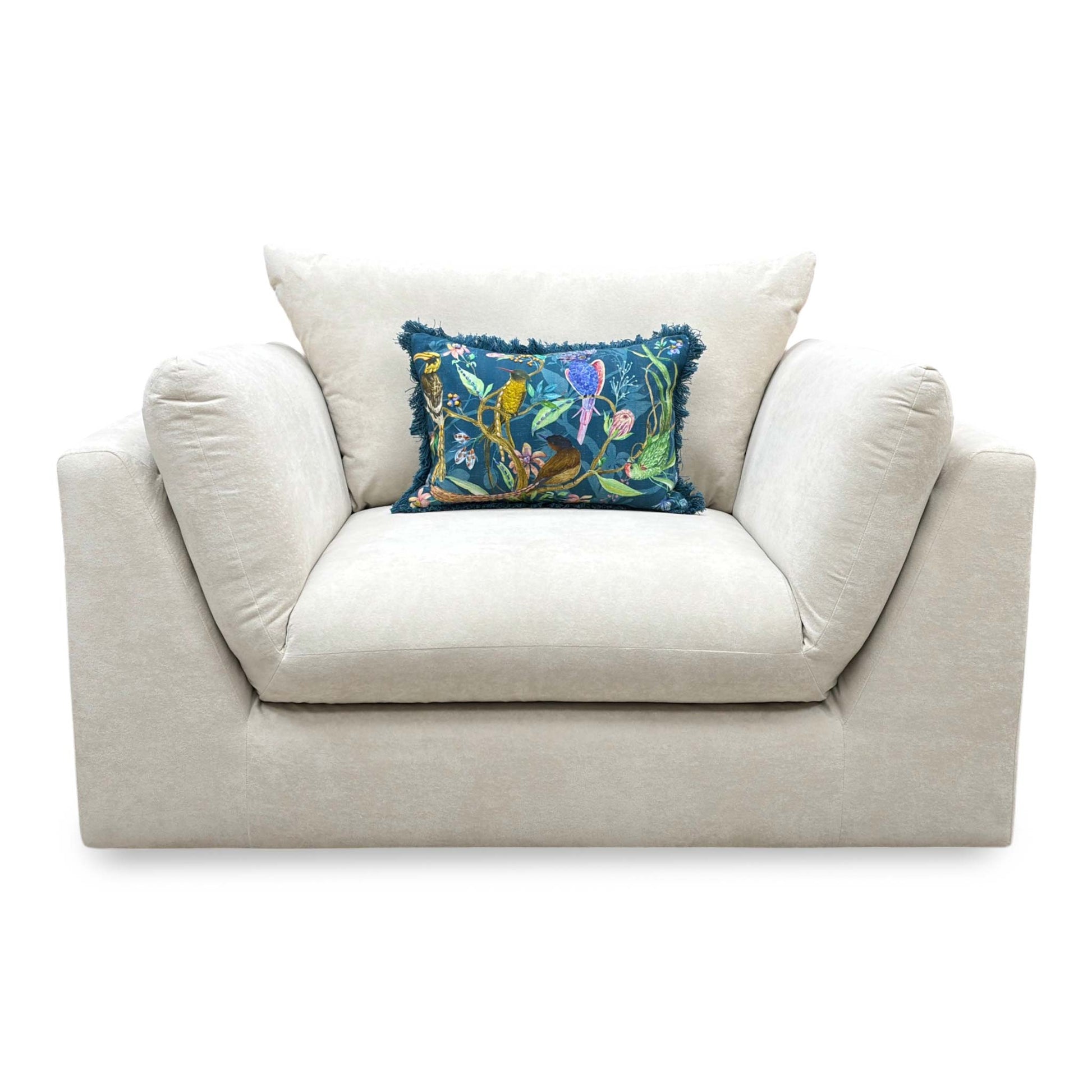 Front-facing look at the cream velvet cuddler chair, highlighting the spacious deep seating area and plump backrest support cushion.