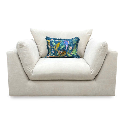 Front-facing look at the cream velvet cuddler chair, highlighting the spacious deep seating area and plump backrest support cushion.
