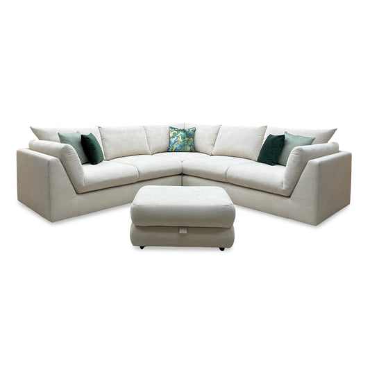 Beige sectional sofa with ottoman on a white background