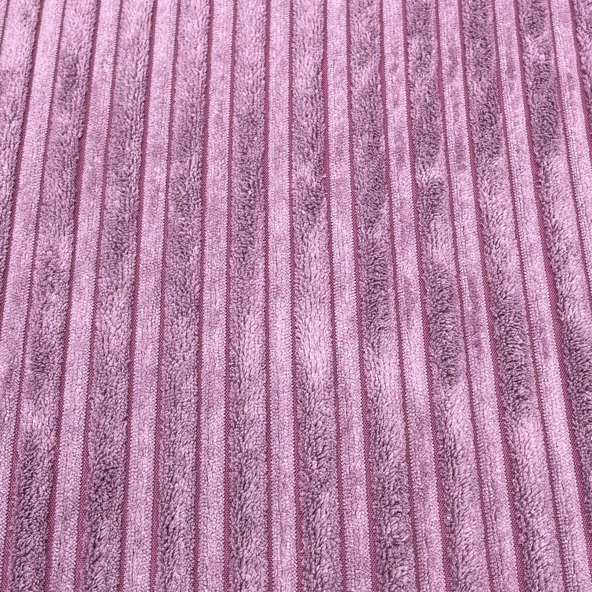 High-definition close-up macro view of the lilac purple Marley jumbo cord textile, displaying the thick, parallel ribbed lines and soft fabric pile.