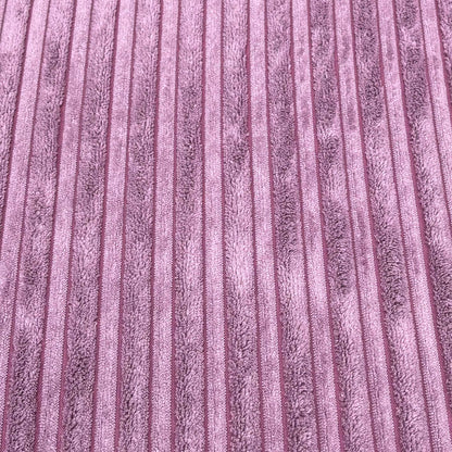 High-definition close-up macro view of the lilac purple Marley jumbo cord textile, displaying the thick, parallel ribbed lines and soft fabric pile.
