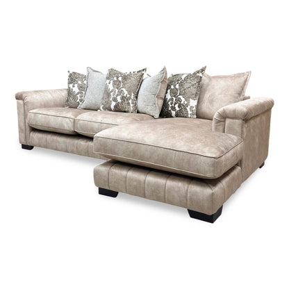 Three-quarter angle perspective emphasizing the deep, extended right-hand chaise section and warm caramel velvet finish.