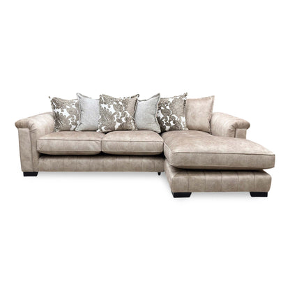 Front profile of the caramel Dolcie pillow back sectional sofa, showcasing the plump scatter cushions, generous seating space, and inviting right-hand chaise lounge layout.