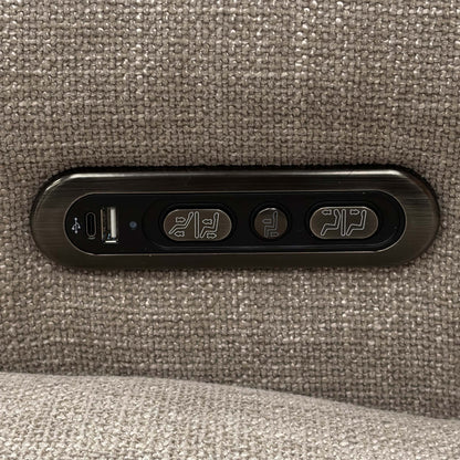 Detail shot of the sleek metallic control panel mounted on the side of the chair, including the buttons for power recline, headrest adjustments, and a built-in USB charging port.