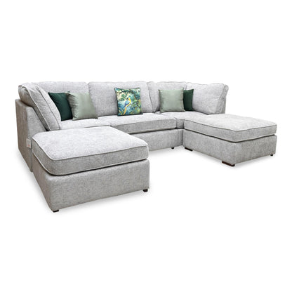 Full view of large-scale Emilia U-shape corner sofa in a shimmering Silver fabric, featuring a symmetrical design with a central seating area flanked by two deep lounging chaise sections.