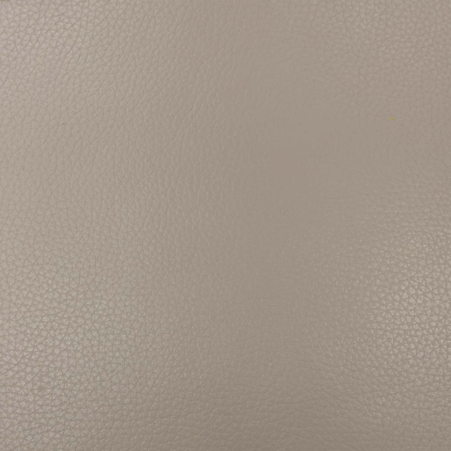 Close-up of the Pebble Cream leather texture, emphasizing the high-quality natural grain and soft-touch finish of the upholstery.