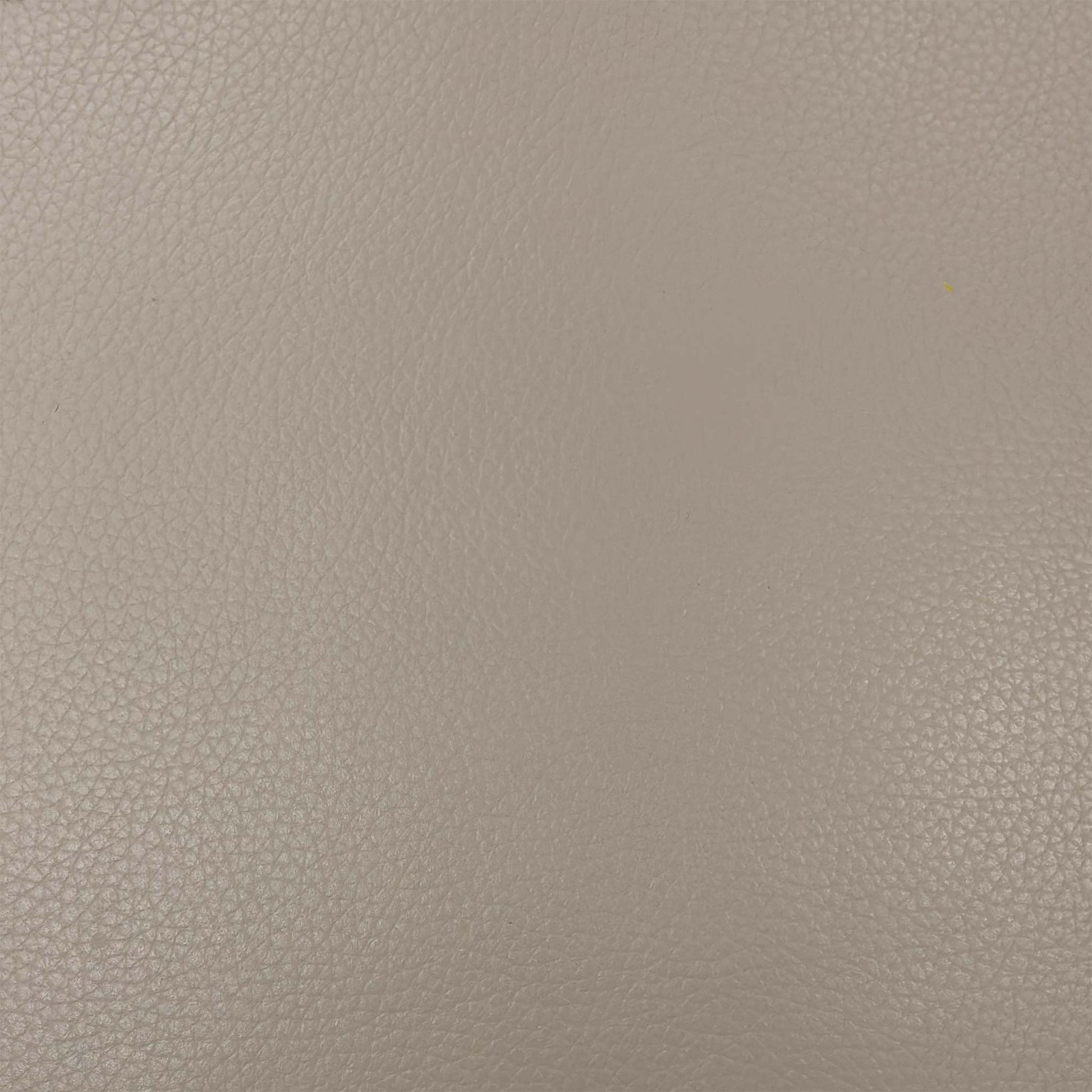 Close-up of the Pebble Cream leather texture, emphasizing the high-quality natural grain and soft-touch finish of the upholstery.