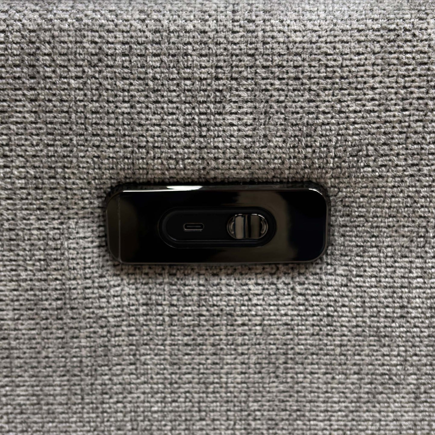 Detailed view of the sturdy circular swivel base mechanism and integrated USB device charging port on the side panel.