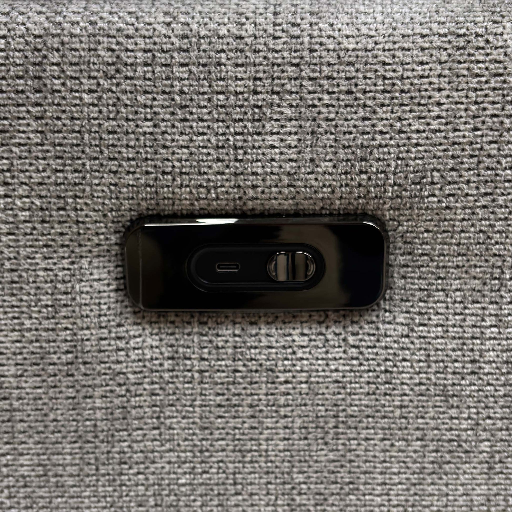 Detailed view of the sturdy circular swivel base mechanism and integrated USB device charging port on the side panel.