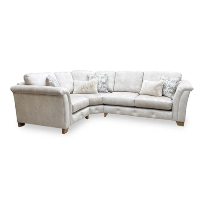 Full view of the Furniture Village ‘Aura’ Kenzo Cream Velvet Classic Back Corner Sofa, showcasing its glamorous style, plush classic back cushions, and spacious design.