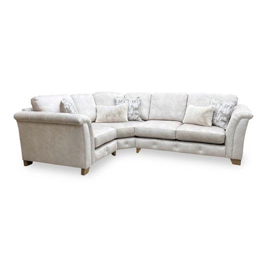 Full view of the Furniture Village ‘Aura’ Kenzo Cream Velvet Classic Back Corner Sofa, showcasing its glamorous style, plush classic back cushions, and spacious design.