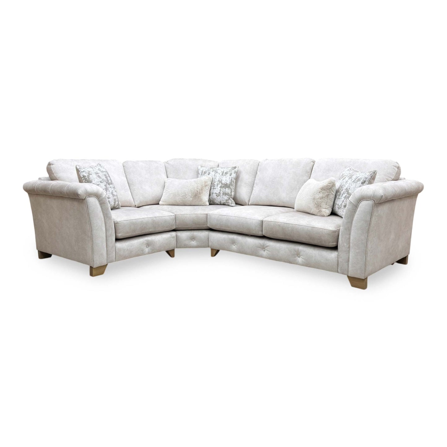Side profile of the corner sofa, highlighting the beautifully sculpted rolled arms and premium velvet fabric finish.