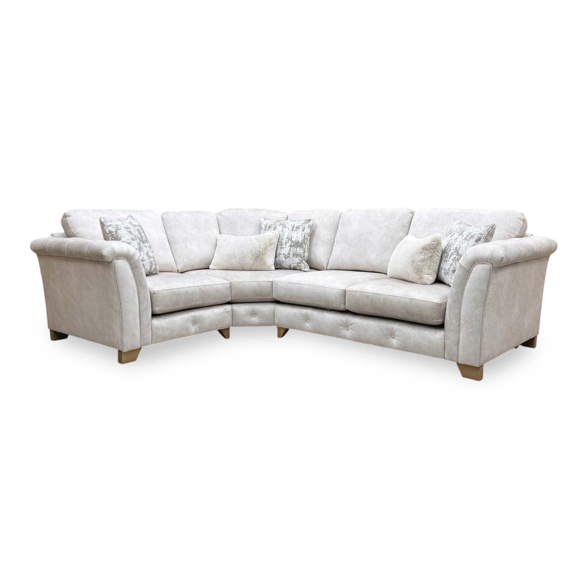 Side profile of the corner sofa, highlighting the beautifully sculpted rolled arms and premium velvet fabric finish.