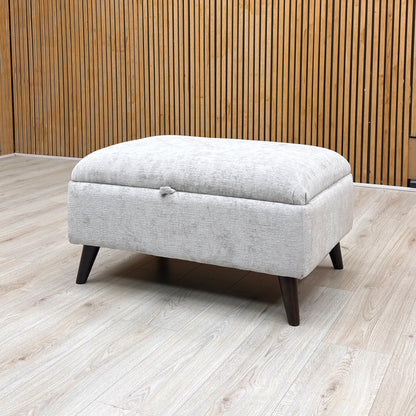 Lifestyle view of the ‘Dior’ bed frame with the mattress platform fully raised from the foot end, demonstrating the expansive, clean storage area and heavy-duty lift mechanism.