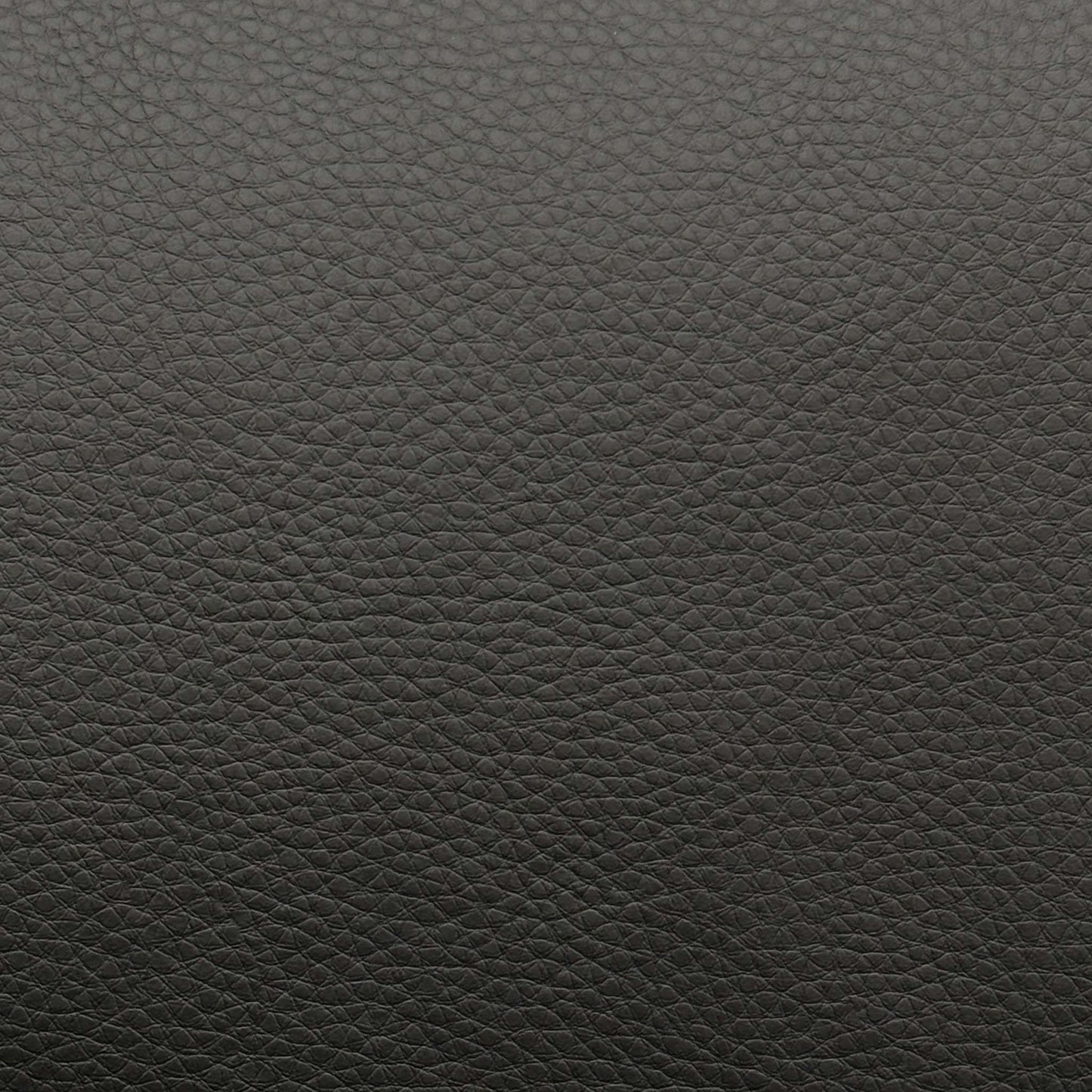 High-definition close-up shot of the premium black leather upholstery, highlighting its authentic fine-grain texture, supple matte finish, and clean, durable seams.