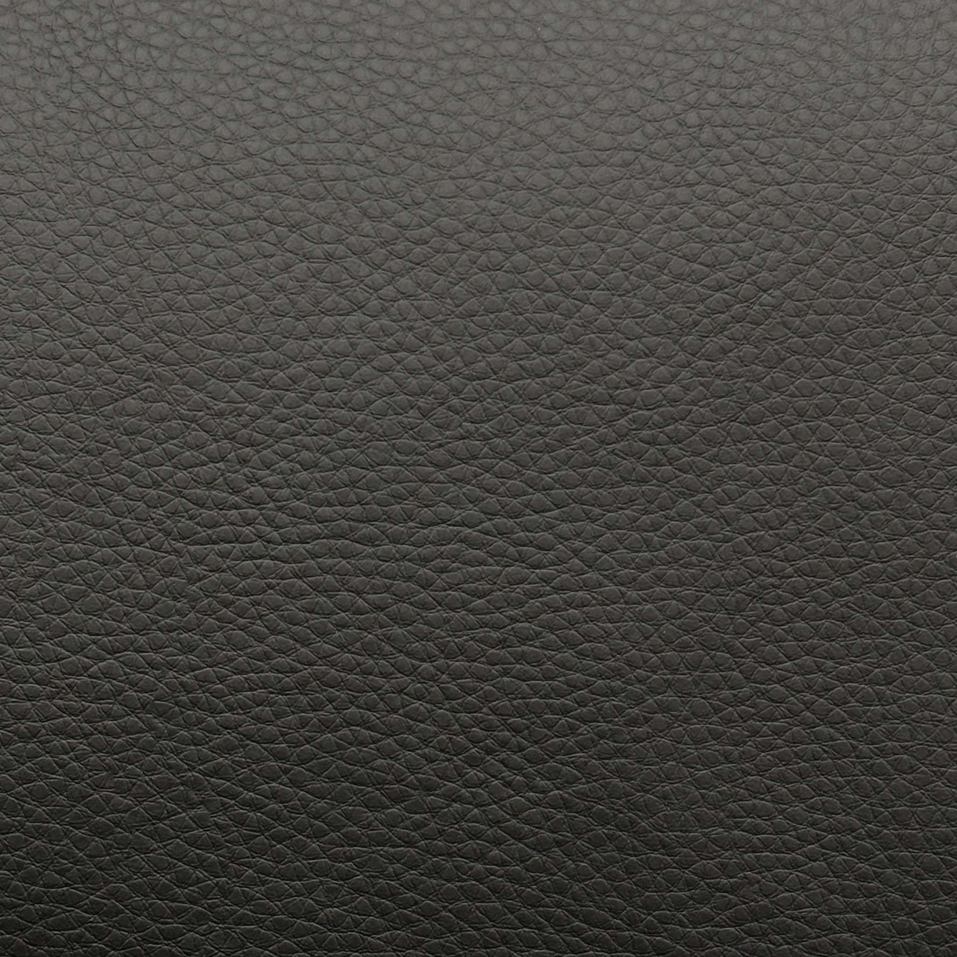 High-definition close-up shot of the premium black leather upholstery, highlighting its authentic fine-grain texture, supple matte finish, and clean, durable seams.