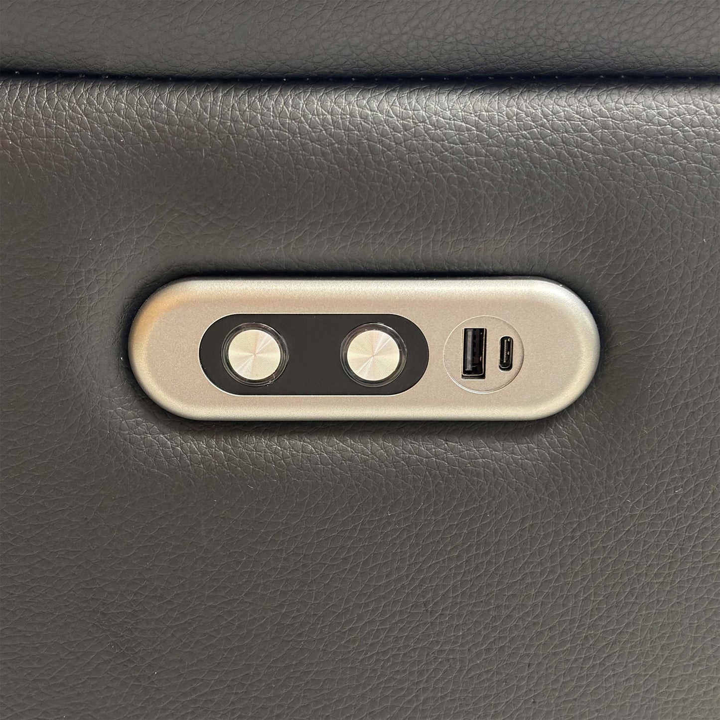 Detail shot focusing on the chrome power control switch panel and integrated USB charging ports on the outer arm, demonstrating the sofa's modern functionality.